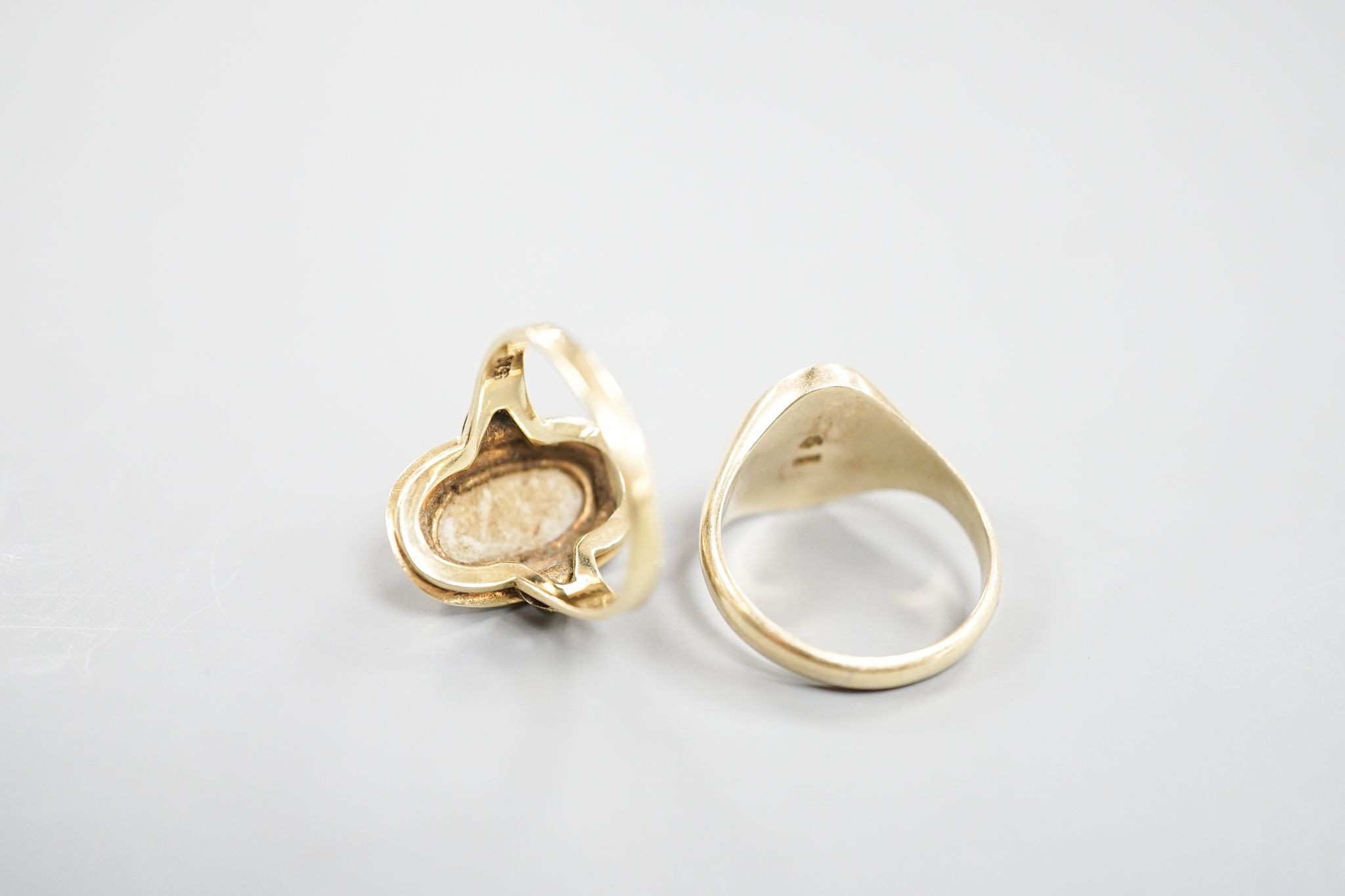 A 585 yellow metal signet ring, with engraved monogram, size O/P and a 585 and white metal and white metal oval dress ring, size O, gross weight 12.6 grams.